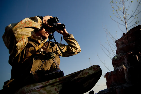 Military Person Holding Bionoculars